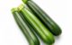 three green cucumbers on a white background
