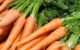 a pile of carrots sitting on top of a table