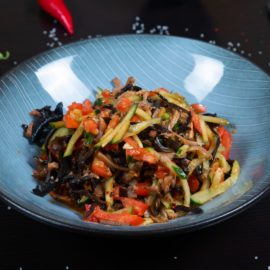 a plate of stir fried vegetables on a table