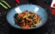 a plate of stir fried vegetables on a table